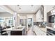 Modern kitchen features stainless steel appliances, granite counters, and eat-in island with hanging lights at 7017 Treetop Ct, York, SC 29745