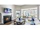 Inviting living room with a fireplace, wood floors, and an open floor plan that flows to the bedroom and second living space at 7017 Treetop Ct, York, SC 29745
