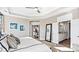 A large main bedroom featuring a tray ceiling, an ensuite bathroom, and ample natural light at 7017 Treetop Ct, York, SC 29745
