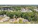 Aerial view of a neighborhood with mature trees and houses of varying sizes and layouts at 7218 Jacobs Fork Ln, Charlotte, NC 28273