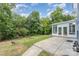 Inviting backyard with a patio, sunroom, lush greenery, and ample space for outdoor activities at 7218 Jacobs Fork Ln, Charlotte, NC 28273