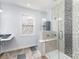 Shower with bench and custom tile adjacent to colorful window at 7218 Jacobs Fork Ln, Charlotte, NC 28273