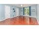 This bedroom features wood floors, large windows and neutral walls at 7218 Jacobs Fork Ln, Charlotte, NC 28273
