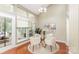 Bright dining room with large windows, a glass table and neutral decor at 7218 Jacobs Fork Ln, Charlotte, NC 28273