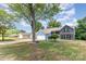 Spacious front yard of a two-story home with mature trees and driveway at 7218 Jacobs Fork Ln, Charlotte, NC 28273