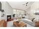 Bright living room featuring a brick fireplace, large windows, hardwood floors, and high ceilings at 7218 Jacobs Fork Ln, Charlotte, NC 28273