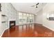 Spacious living room with a brick fireplace, and hardwood floors, offering natural light at 7218 Jacobs Fork Ln, Charlotte, NC 28273