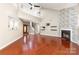 Open concept living room with hardwood floors, fireplace, and staircase at 7218 Jacobs Fork Ln, Charlotte, NC 28273