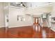 Open concept living room with hardwood floors, fireplace, staircase and views to the entryway at 7218 Jacobs Fork Ln, Charlotte, NC 28273