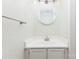 Clean powder room features vanity with storage and round mirror at 7218 Jacobs Fork Ln, Charlotte, NC 28273