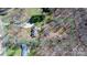 A high aerial view of a single Gathering home on a large lot surrounded by mature trees at 7648 Forest Oak Dr, Denver, NC 28037