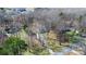 An aerial view of a single Gathering home situated in a wooded area, accessed by a long, private driveway at 7648 Forest Oak Dr, Denver, NC 28037