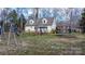 Expansive backyard featuring a playset, tree swing, and trampoline, ideal for Gathering fun at 7648 Forest Oak Dr, Denver, NC 28037