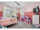 Pink bedroom featuring a ceiling fan, and natural light with two windows at 7648 Forest Oak Dr, Denver, NC 28037
