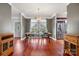 Elegant dining room with a large table, stylish chandelier, hardwood floors, and bright windows offering ample light at 7648 Forest Oak Dr, Denver, NC 28037