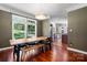 Bright dining area features wood floors, rustic table, lots of windows and an open view of the kitchen at 7648 Forest Oak Dr, Denver, NC 28037