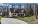 Charming two-story home with inviting front porch, cozy deck, and long driveway, all nestled in a serene landscape at 7648 Forest Oak Dr, Denver, NC 28037