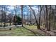Two-story home with a long driveway and expansive lawn, offering privacy and space surrounded by trees at 7648 Forest Oak Dr, Denver, NC 28037