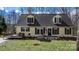 Charming two-story home with a welcoming front porch and a cozy deck, surrounded by lush greenery at 7648 Forest Oak Dr, Denver, NC 28037