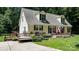 Attractive home featuring a welcoming porch, a wooden deck, dormer windows and an inviting driveway at 7648 Forest Oak Dr, Denver, NC 28037