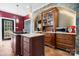 Modern kitchen featuring a center island with cooktop, custom cabinetry, and tiled flooring, perfect for cooking at 7648 Forest Oak Dr, Denver, NC 28037