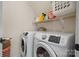 Convenient laundry room with modern appliances and practical shelving for efficient storage at 7648 Forest Oak Dr, Denver, NC 28037