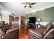 Spacious living room featuring hardwood floors, modern lighting, and comfortable seating, perfect for relaxation at 7648 Forest Oak Dr, Denver, NC 28037