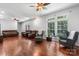 Spacious living room with wood floors, ceiling fans, accent chairs and comfortable brown leather furniture at 7648 Forest Oak Dr, Denver, NC 28037