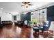 Spacious and modern living room with hardwood floors, ample seating, and large windows offering natural light at 7648 Forest Oak Dr, Denver, NC 28037