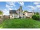 Well-manicured backyard featuring a patio area and full perimeter fencing at 8414 Oak Ne Dr, Charlotte, NC 28269