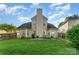 Spacious backyard with a well-kept lawn, patio, grill, and fenced perimeter at 8414 Oak Ne Dr, Charlotte, NC 28269