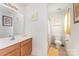 Well-lit bathroom featuring a vanity with ample storage, and a shower at 8414 Oak Ne Dr, Charlotte, NC 28269