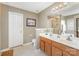 Bathroom with double sink vanity, tile flooring and large mirror with framed artwork at 8414 Oak Ne Dr, Charlotte, NC 28269