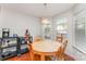 Bright breakfast nook with bay windows, wood floors, round wooden table and adjacent coffee and mixer station at 8414 Oak Ne Dr, Charlotte, NC 28269
