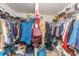 Overstuffed walk-in closet with clothing and accessories on metal shelving at 8414 Oak Ne Dr, Charlotte, NC 28269