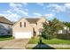 Charming, well-maintained two-story home featuring a two-car garage and beautifully landscaped front yard at 8414 Oak Ne Dr, Charlotte, NC 28269
