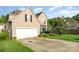 Attractive home with a two-car garage, a well-kept lawn, and established greenery at 8414 Oak Ne Dr, Charlotte, NC 28269