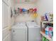 Laundry room with white washer and dryer, plus shelving for storage at 8414 Oak Ne Dr, Charlotte, NC 28269