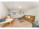 Comfortable living area with brown sofa, table and chairs at 8414 Oak Ne Dr, Charlotte, NC 28269