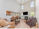 Open-concept living room showcasing high ceilings, a fireplace, and seamless flow into the dining area at 8414 Oak Ne Dr, Charlotte, NC 28269
