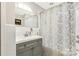 Bright bathroom features a shower over tub and a decorative gold floral shower curtain at 981 Sherwood Cir, Lancaster, SC 29720
