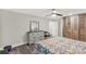 Bedroom with neutral walls, wood floors, dresser and mirror, ceiling fan, and multicolor quilt at 981 Sherwood Cir, Lancaster, SC 29720