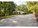 Ranch style home with brick accents, a long driveway, and mature trees surrounding the property at 981 Sherwood Cir, Lancaster, SC 29720