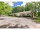 Exterior of a ranch style house with covered parking and mature shade trees at 981 Sherwood Cir, Lancaster, SC 29720