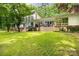 Back of a white house with large windows, patio, and landscaped lawn at 981 Sherwood Cir, Lancaster, SC 29720