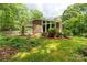 Brick house with large windows, manicured lawn, and covered parking at 981 Sherwood Cir, Lancaster, SC 29720
