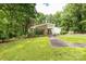 Beautiful single-story home featuring a brick facade and lush landscaping on a green, tree-lined lot at 981 Sherwood Cir, Lancaster, SC 29720