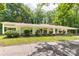 A home's long side with several horizontal windows, nicely landscaped, and a tree-lined property at 981 Sherwood Cir, Lancaster, SC 29720