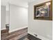 Neutral-colored hallway with hardwood floors and a decorative piece of artwork on the wall at 981 Sherwood Cir, Lancaster, SC 29720