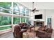 Bright living room with large windows, a fireplace, and comfortable leather seating at 981 Sherwood Cir, Lancaster, SC 29720